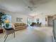 Bright living room with plush neutral furniture, a ceiling fan, and views of the outdoor living space at 2065 Braxton St, Clermont, FL 34711