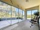 Enclosed lanai with glass sliders offering views of the golf course, plus comfortable seating at 2065 Braxton St, Clermont, FL 34711