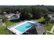 Aerial view of a community pool with lounge chairs and hot tub, surrounded by greenery at 2065 Braxton St, Clermont, FL 34711