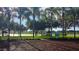 Picturesque community park with a lake, gazebos, and palm trees, perfect for outdoor activities at 21410 Royal St Georges Ln, Leesburg, FL 34748