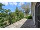 The backyard patio is paved with brick and features green bushes for additional privacy at 22027 Belgian Ct, Mount Dora, FL 32757