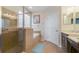 Bathroom with a glass-enclosed shower, soaking tub, tiled walls, and double vanity sinks, offering a luxurious feel at 22027 Belgian Ct, Mount Dora, FL 32757