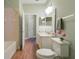 This beautiful bathroom has green walls, white and gray sink counter and a large mirror over the sink at 22027 Belgian Ct, Mount Dora, FL 32757