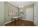 This dining room features a table, wood floors, white trim and paint, and a window with blinds at 22027 Belgian Ct, Mount Dora, FL 32757