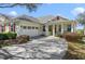 Charming single-story home featuring a two-car garage, well-maintained landscaping, and a welcoming front porch at 22027 Belgian Ct, Mount Dora, FL 32757