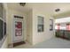 Covered front porch with a glass front door, offering natural light and creating an inviting entrance to the home at 22027 Belgian Ct, Mount Dora, FL 32757