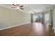Spacious living room with wood-look tile flooring, two ceiling fans, and sliding glass doors to the outdoor space at 22027 Belgian Ct, Mount Dora, FL 32757