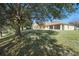 Spacious backyard with mature trees providing shade and a tranquil atmosphere at 2471 Holly Berry Cir, Clermont, FL 34711