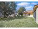 Expansive backyard with lush lawn, offering a serene and private outdoor retreat at 2471 Holly Berry Cir, Clermont, FL 34711
