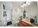 Bathroom features a single sink vanity, a toilet, and a walk-in shower leading to an outside entry at 2471 Holly Berry Cir, Clermont, FL 34711