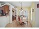 Cozy dining room with chandelier and natural light, open to the kitchen at 2471 Holly Berry Cir, Clermont, FL 34711