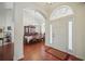Elegant foyer with hardwood floors and view to the formal dining area at 2471 Holly Berry Cir, Clermont, FL 34711