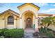 Inviting front entrance with an arched entryway and decorative accents at 2471 Holly Berry Cir, Clermont, FL 34711