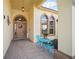 Welcoming front porch with decorative furniture and tiled flooring at 2471 Holly Berry Cir, Clermont, FL 34711