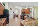 Bright kitchen showcasing granite countertops, tile flooring, wood cabinets, and black appliances at 2471 Holly Berry Cir, Clermont, FL 34711