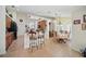 Open kitchen and dining area with barstool seating and plenty of natural light at 2471 Holly Berry Cir, Clermont, FL 34711