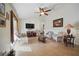 Spacious living room featuring tile flooring, ceiling fan, and ample natural light at 2471 Holly Berry Cir, Clermont, FL 34711