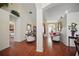 Open-concept living space with hardwood floors and elegant furnishings at 2471 Holly Berry Cir, Clermont, FL 34711