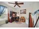 Cozy office space features a ceiling fan, built-in shelving, and a window with natural light at 2471 Holly Berry Cir, Clermont, FL 34711