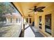 Relaxing screened patio with ceiling fans, leading to the backyard and creating a perfect outdoor space at 2471 Holly Berry Cir, Clermont, FL 34711