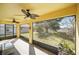 Relaxing screened-in patio with ceiling fans overlooks a spacious backyard at 2471 Holly Berry Cir, Clermont, FL 34711