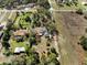 Aerial view of property showcasing mature trees surrounding the home, nearby streets, and surrounding land at 25013 Adair Ave, Sorrento, FL 32776