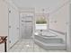 Relaxing bathroom with a large soaking tub, separate shower, and elegant fixtures at 25013 Adair Ave, Sorrento, FL 32776