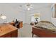 Bedroom featuring a desk, a ceiling fan and natural light at 25013 Adair Ave, Sorrento, FL 32776