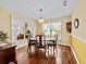 Well-lit dining area with hardwood floors, classic furnishings, and views to the outside at 25013 Adair Ave, Sorrento, FL 32776