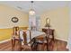 Warm dining area with wood flooring, traditional decor, and natural light from windows at 25013 Adair Ave, Sorrento, FL 32776