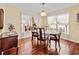 Elegant dining room with hardwood floors, a chandelier, and natural light from the windows at 25013 Adair Ave, Sorrento, FL 32776