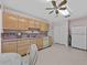 Spacious kitchen featuring ample cabinet space, classic appliances, and neutral countertops at 25013 Adair Ave, Sorrento, FL 32776