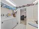 Laundry area featuring a washer, a dryer and access to the living area at 25013 Adair Ave, Sorrento, FL 32776