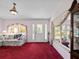 Bright living room with large windows, front door, and elegant decorative details at 25013 Adair Ave, Sorrento, FL 32776