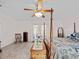 Bright main bedroom with access to outdoor patio, ceiling fan, and classic furnishings at 25013 Adair Ave, Sorrento, FL 32776
