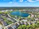 Aerial view shows lakeside homes and schools under a sunny, blue sky at 2505 Civitas Pl, Casselberry, FL 32707
