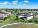 An aerial view of a suburban neighborhood with manicured lawns and a scenic lake at 2505 Civitas Pl, Casselberry, FL 32707
