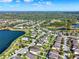 An aerial shot showing homes with pools nestled alongside a serene lake at 2505 Civitas Pl, Casselberry, FL 32707