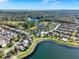 Aerial view of homes near a lake and green spaces under a blue sky at 2505 Civitas Pl, Casselberry, FL 32707