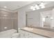 Bathroom featuring a vanity sink, shower-tub combination, and neutral gray tile at 2505 Civitas Pl, Casselberry, FL 32707