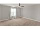 Bedroom with large window, ceiling fan, and neutral carpet at 2505 Civitas Pl, Casselberry, FL 32707