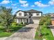 Stunning two-story home with brick driveway, lush landscaping, and a picturesque view of the neighborhood at 2505 Civitas Pl, Casselberry, FL 32707