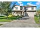 Beautiful two-story home featuring a brick driveway and mature landscaping around the property at 2505 Civitas Pl, Casselberry, FL 32707