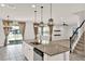 Spacious kitchen island with sink, granite countertops, and modern pendant lighting at 2505 Civitas Pl, Casselberry, FL 32707