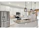 Modern kitchen with stainless steel appliances, granite countertops, and a large central island at 2505 Civitas Pl, Casselberry, FL 32707