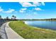 Scenic view of community lake with walking path and lush green grass at 2505 Civitas Pl, Casselberry, FL 32707