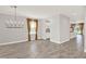 Open-concept living room with ceramic tile floors, decorative chandelier, and a view of the kitchen and outdoor space at 2505 Civitas Pl, Casselberry, FL 32707