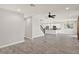 Spacious living room featuring tile flooring, decorative lighting, and a view of the staircase and kitchen at 2505 Civitas Pl, Casselberry, FL 32707