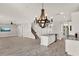 Open-concept living space features tile floors, a wooden chandelier, and access to the kitchen at 2505 Civitas Pl, Casselberry, FL 32707
