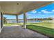 Covered patio featuring brick pavers, lake view, and manicured lawn at 2505 Civitas Pl, Casselberry, FL 32707
